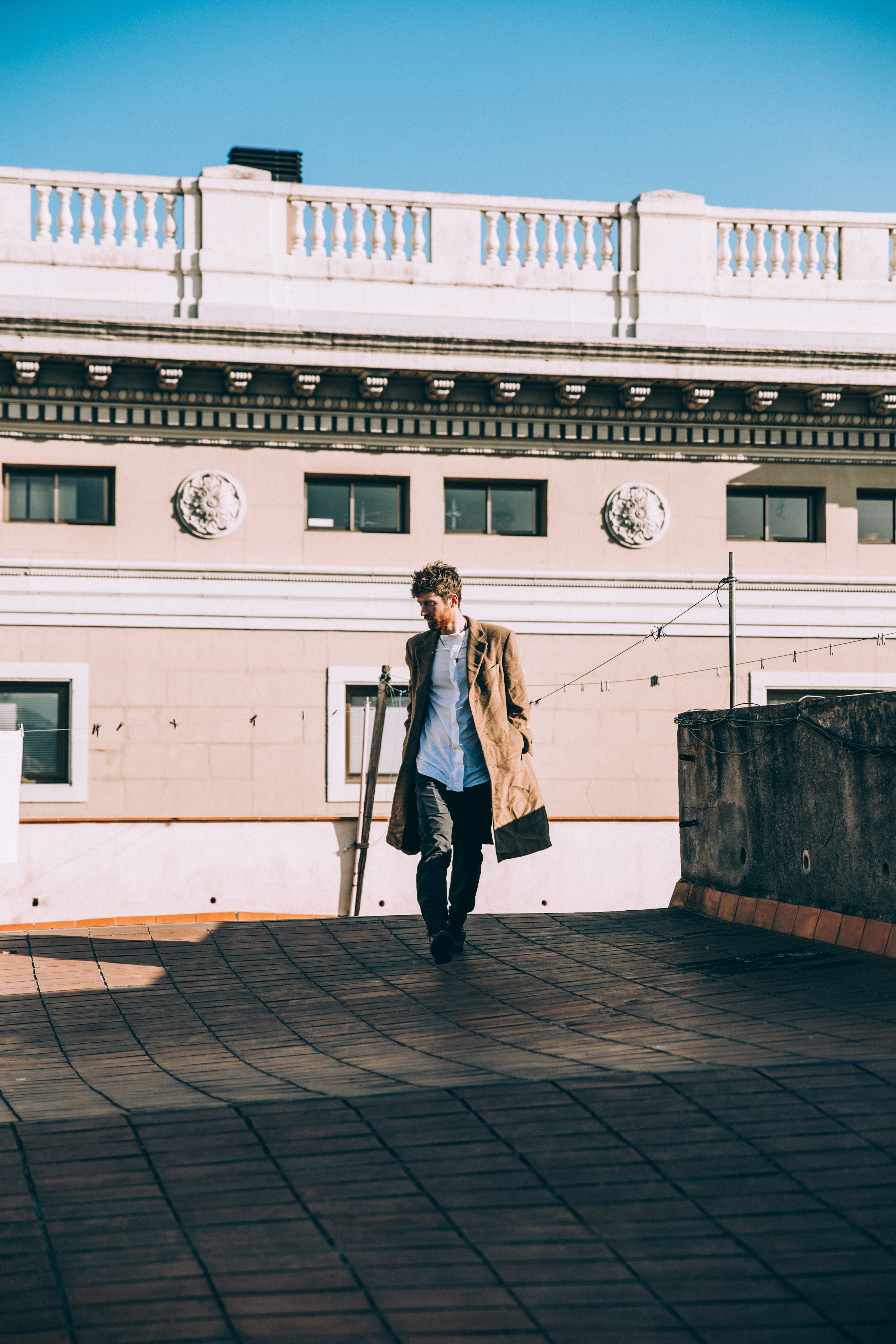 files/young-man-on-rooftop-in-brown-coat.jpg